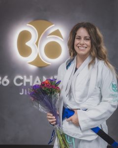 woman in ju jitsu uniform with flowers
