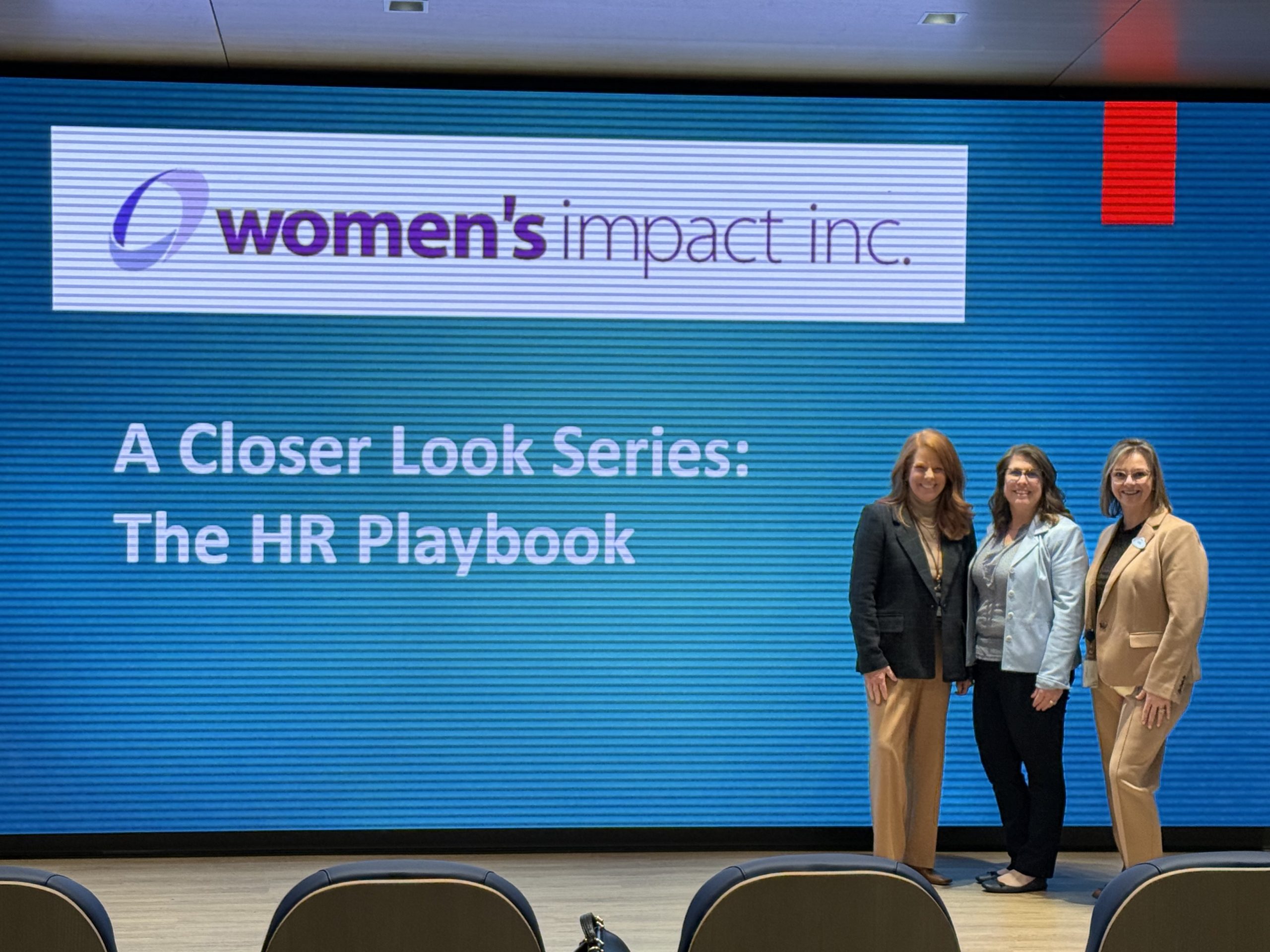 Three women in front of a screen