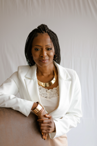 Woman of color in a white suit